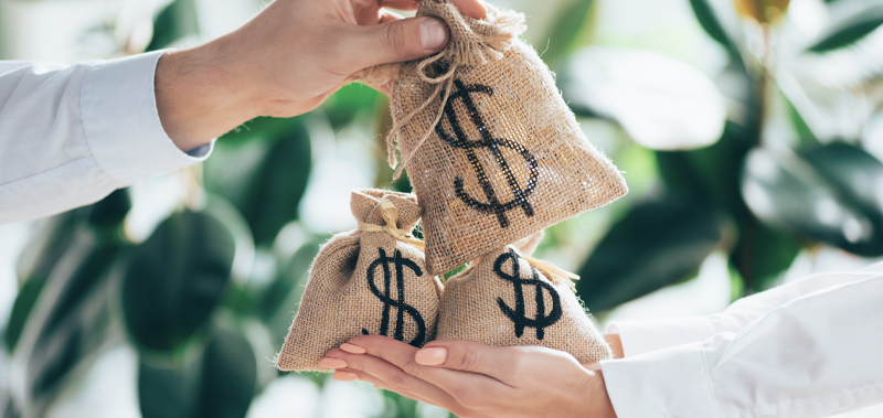 A person giving another individual bags of money, symbolizing the movement of equity and financial changes in business ownership.