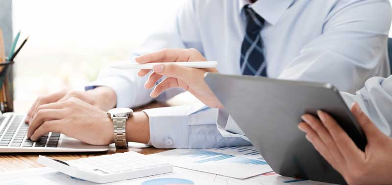 Professionals collaborating to prepare an IFRS-compliant financial statement, working together in a modern office setting.