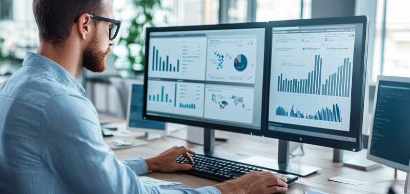 A financial professional using technology, including dashboards and analytics tools, to enhance financial planning and decision-making.